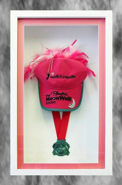 Medal and baseball cap for breast cancer charity walk